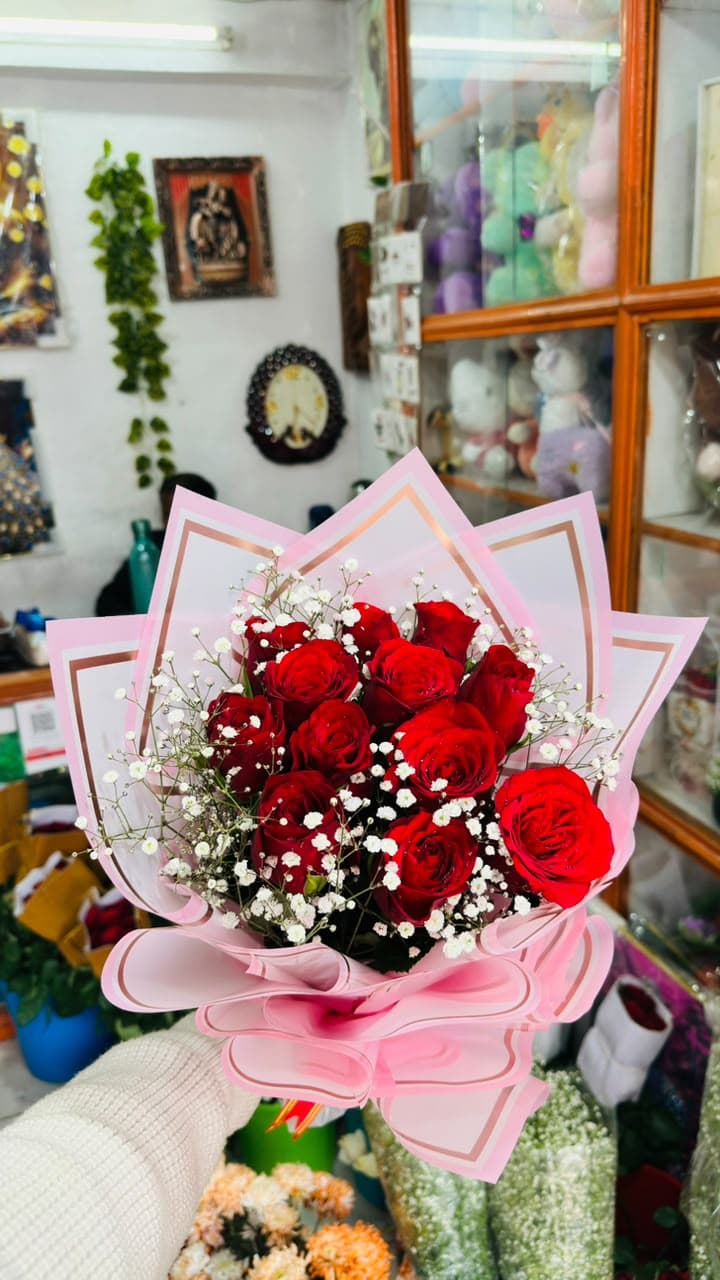 Red roses and baby's breath in pink wrapping